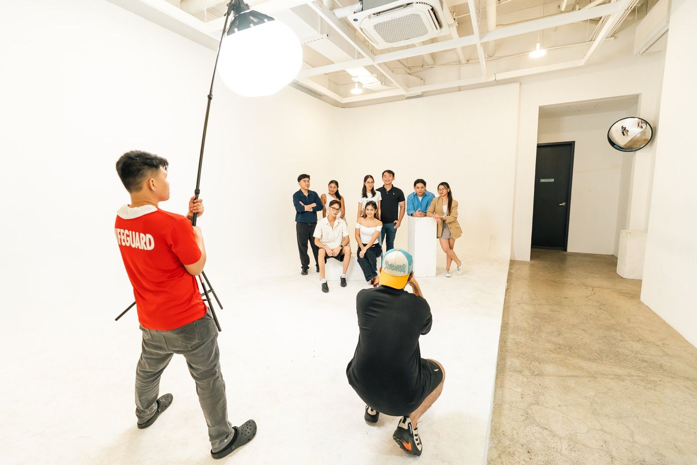 A crew shooting a group portrait on the Studio 1 infinity wall